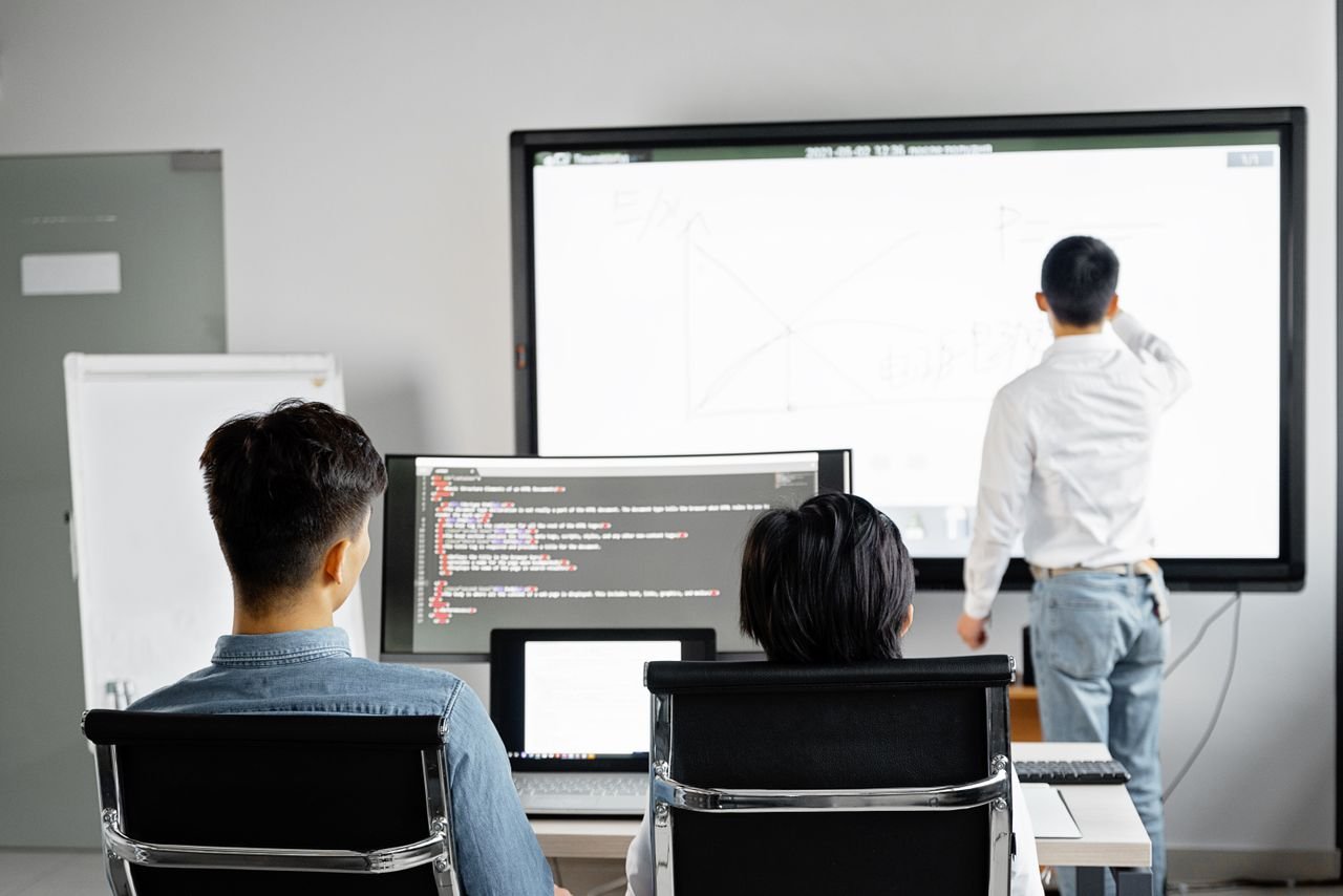 Home Team conducting a business presentation with technology in a modern office setting.