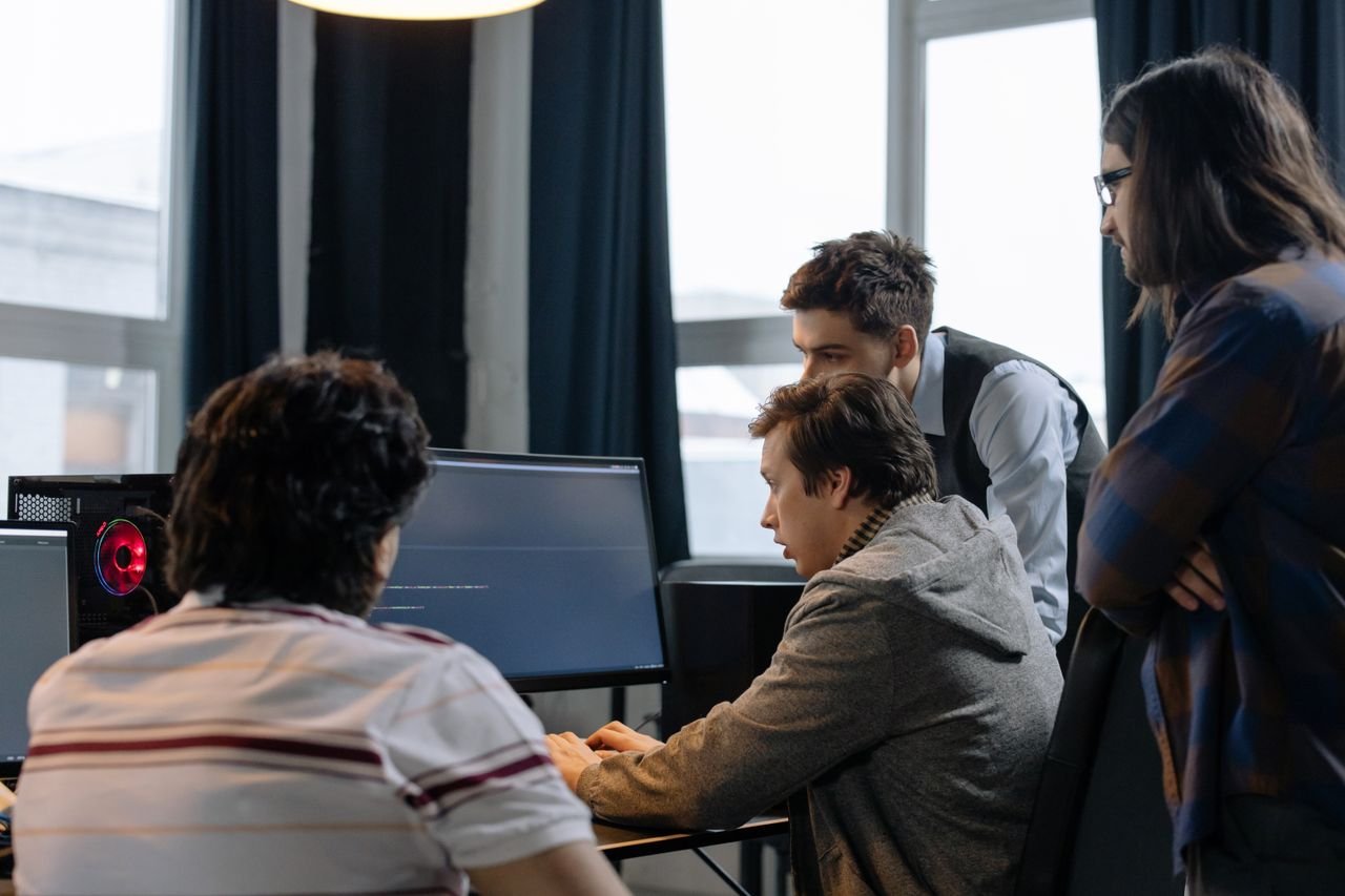 Home Group of developers working together on a computer programming project indoors.